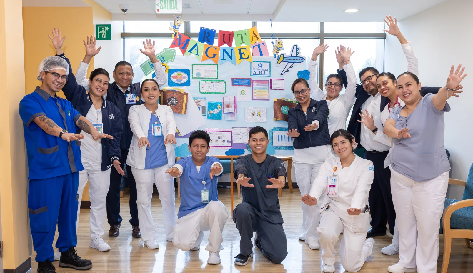 Happy nurses with a diagram of the path to Magnet certification