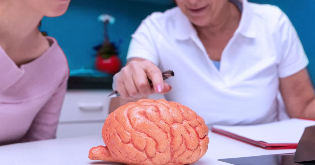 Doctora explicándole a paciente qué es aneurisma cerebral y en que zonas se puede desarrollar.